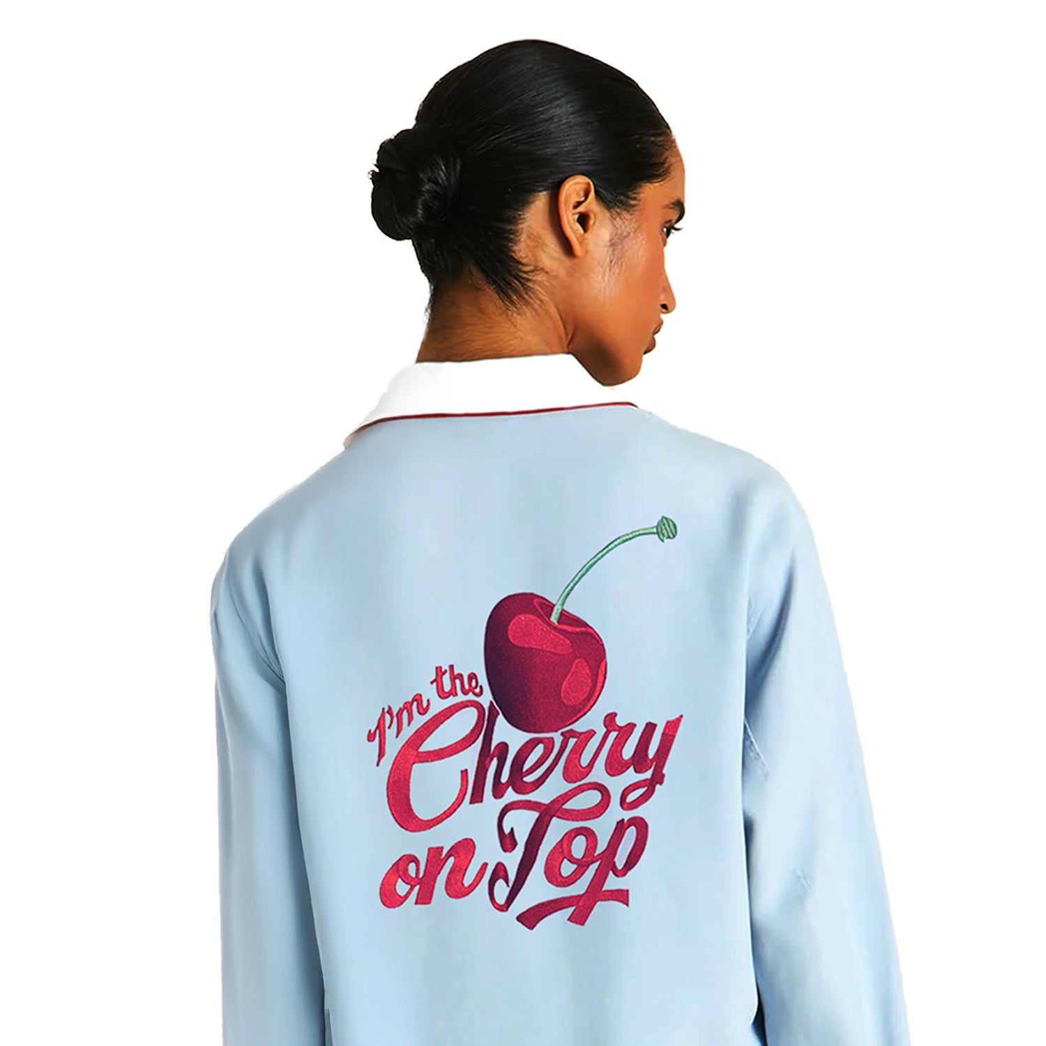 Back view of a woman wearing a light blue spa robe with cherry graphic and “Cherry on Top” text on the back
