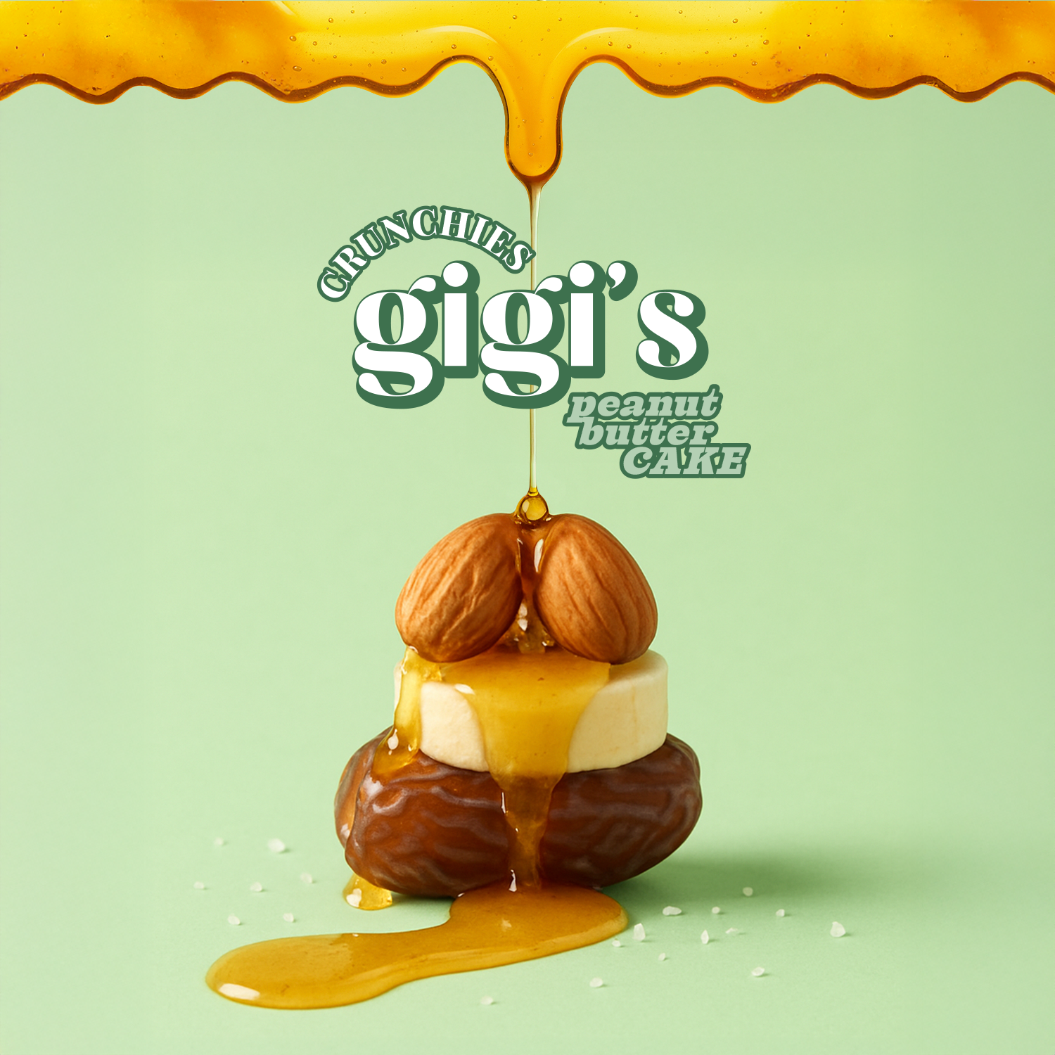 Peanut butter cake with almonds and caramel drizzle on a light green background, featuring 'Crunchies Gigi's' branding.